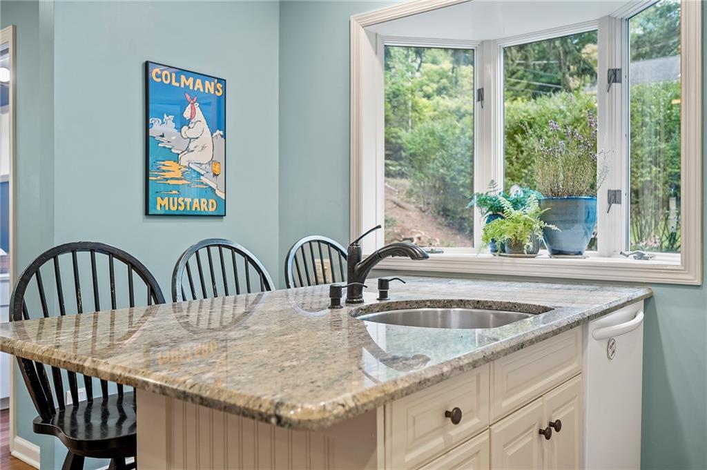 325 Sycamore Road Sewickley, PA 15143 - Photo 18 of 49 a kitchen with a table a sink and cabinets