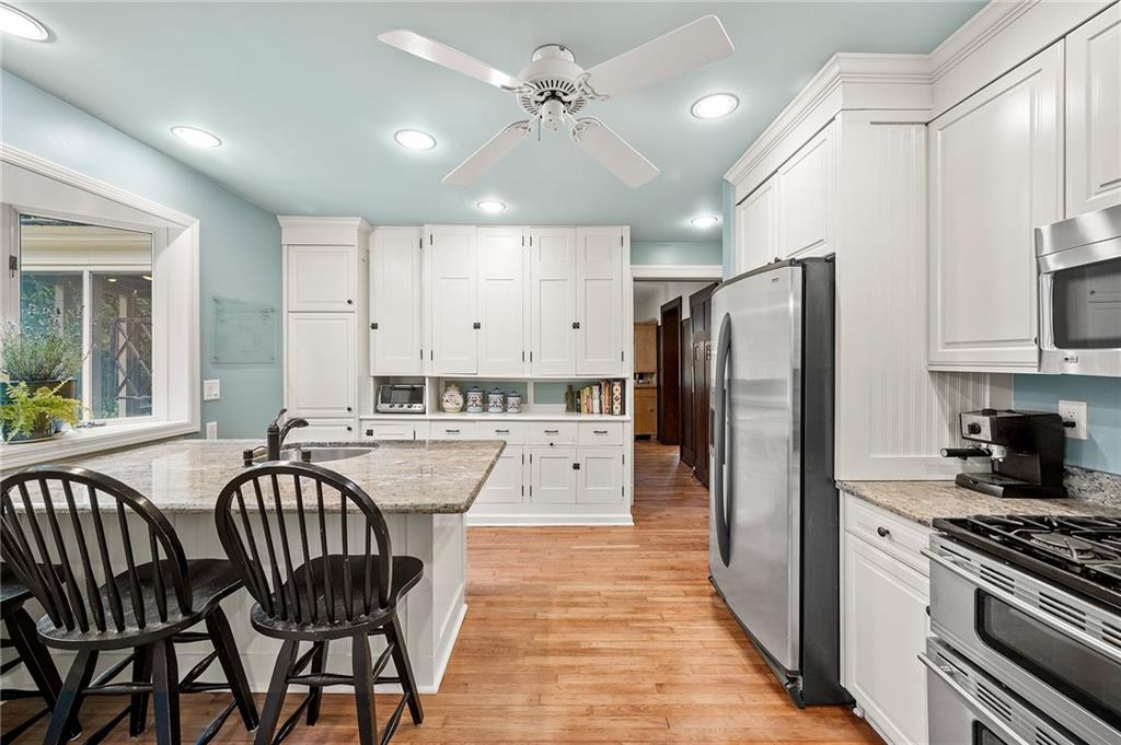 325 Sycamore Road Sewickley, PA 15143 - Photo 19 of 49 a kitchen with stainless steel appliances granite countertop a dining table chairs refrigerator and cabinets
