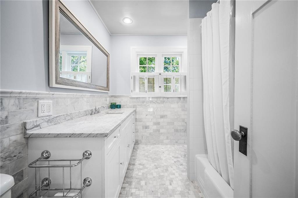 325 Sycamore Road Sewickley, PA 15143 - Photo 26 of 49 a bathroom with a granite countertop sink a mirror and a shower