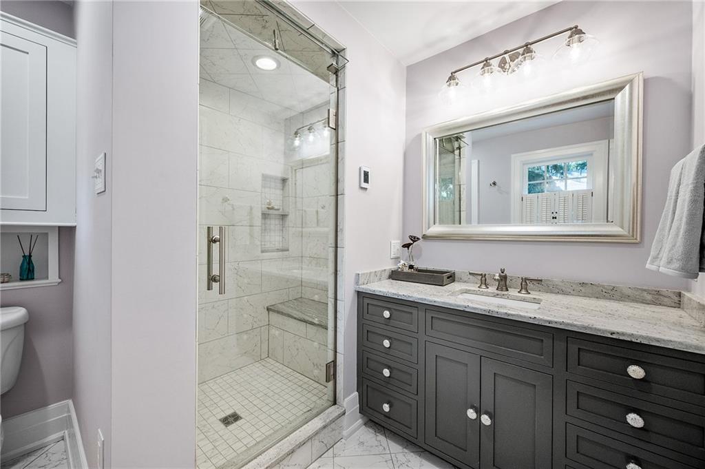 325 Sycamore Road Sewickley, PA 15143 - Photo 31 of 49 a bathroom with a shower tub double vanity and a mirror