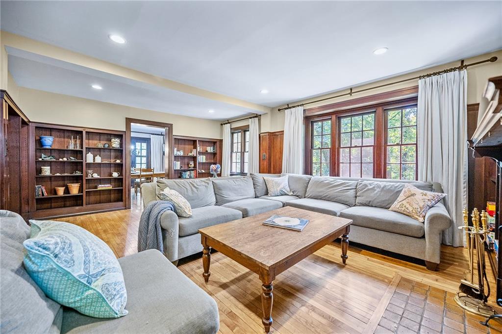325 Sycamore Road Sewickley, PA 15143 - Photo 6 of 49 a living room with furniture a bookshelf and a large window