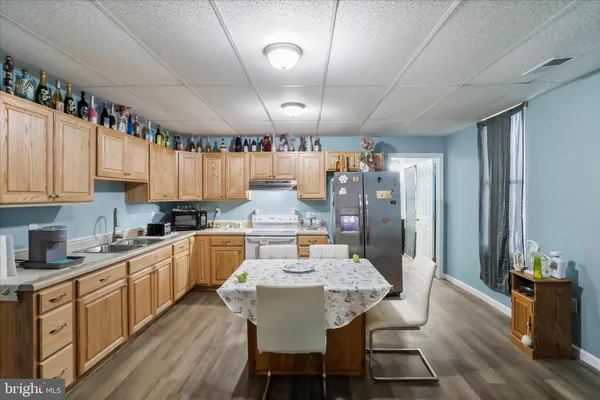 a large kitchen with a table and chairs in it