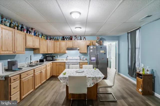 a large kitchen with a table and chairs in it