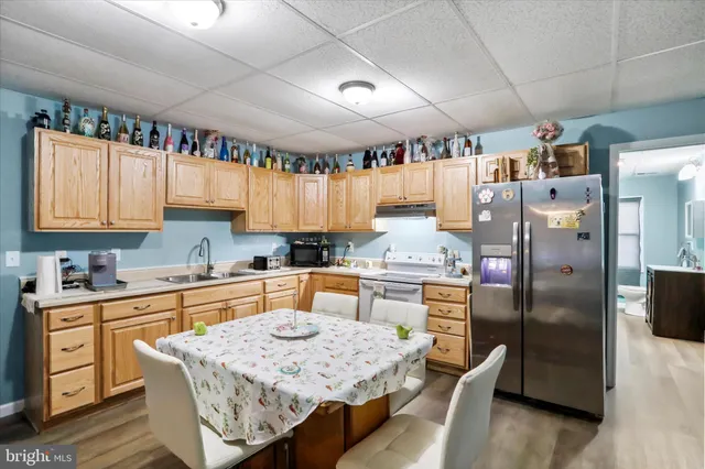 a kitchen with stainless steel appliances granite countertop a sink refrigerator and cabinets