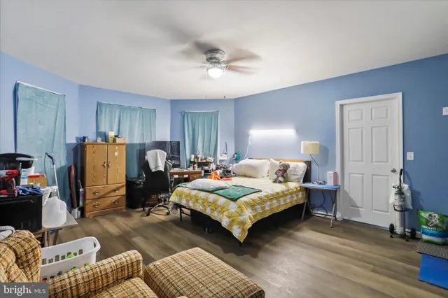 a bedroom with a bed couch and a window