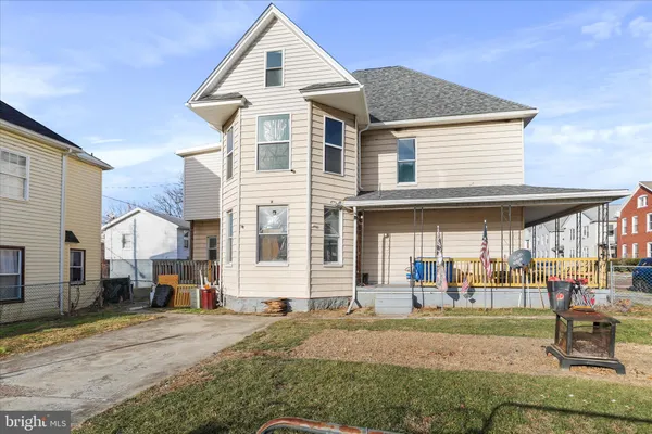 a view of a house with a yard and lawn chairs