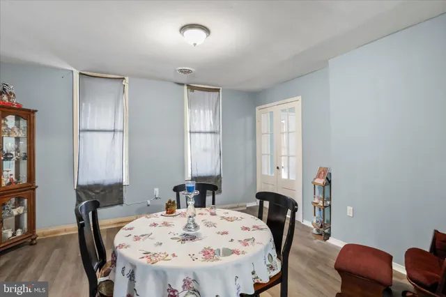 a view of a a dining room with furniture window and wooden floor