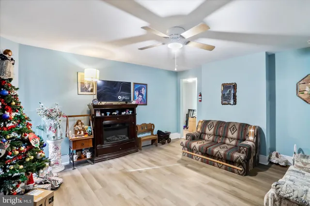 a living room with furniture and flowers