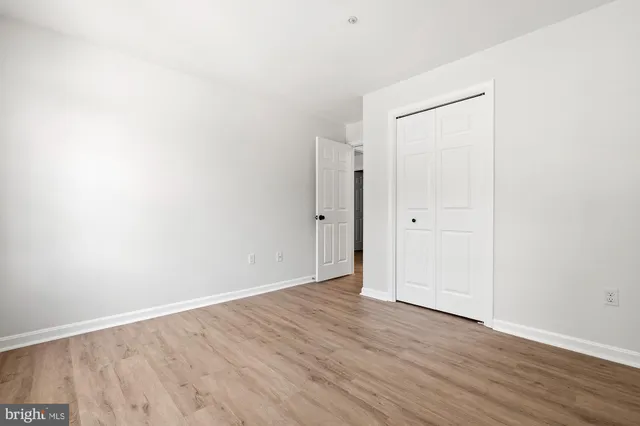 an empty room with wooden floor