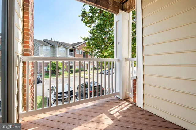 a view of a balcony with wooden floor