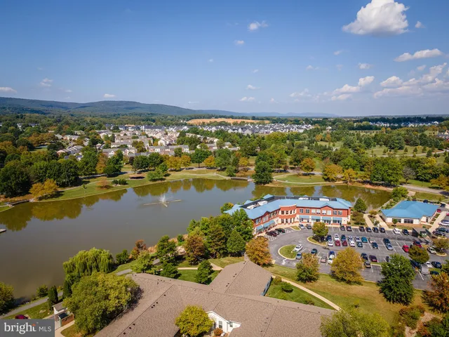 an aerial view of residential building and lake