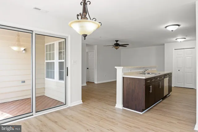 a kitchen with stainless steel appliances granite countertop a sink and a refrigerator