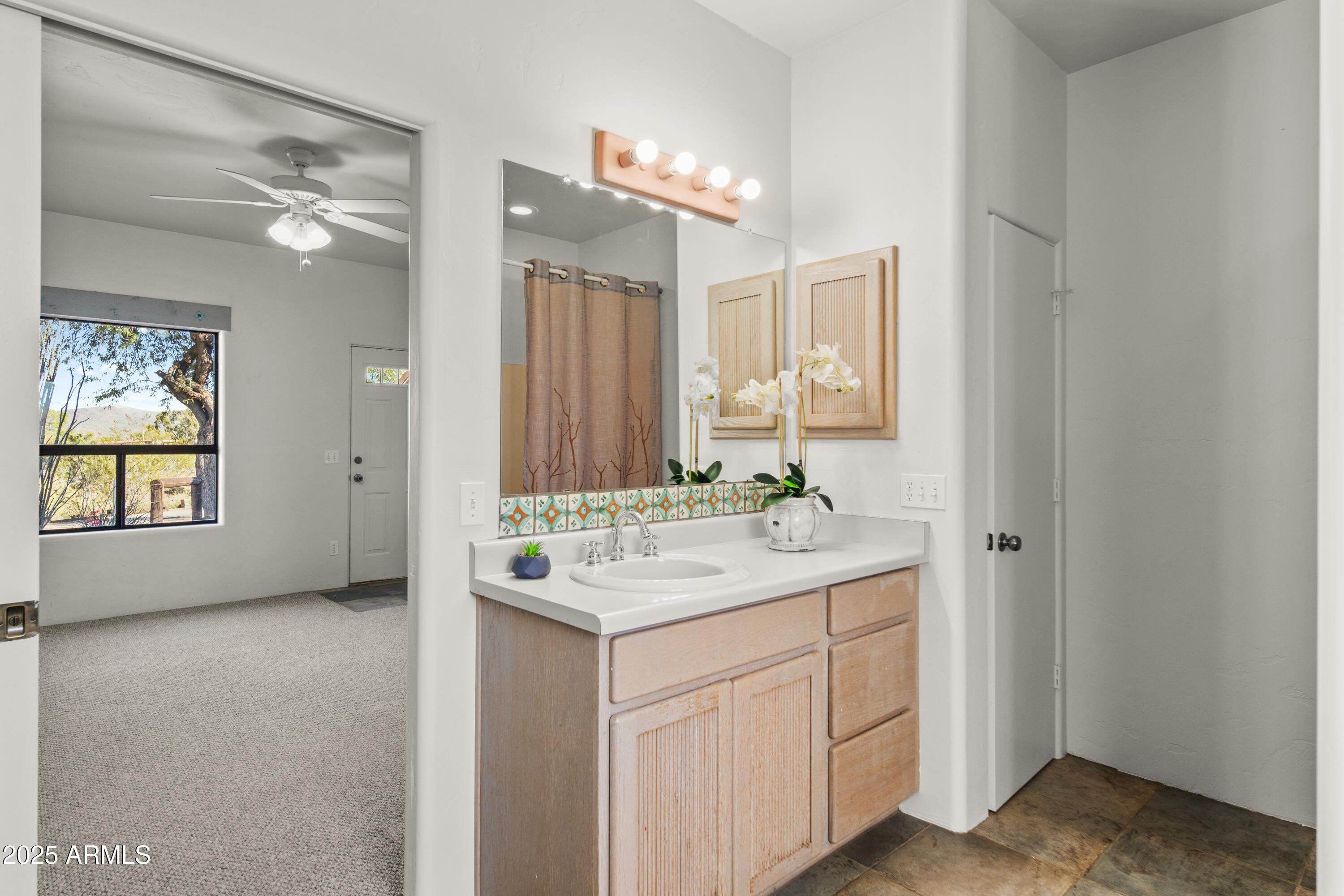18330 Moonlight Mesa Road Wickenburg, AZ 85390 - Photo 14 of 31 a bathroom with a sink a vanity and a mirror