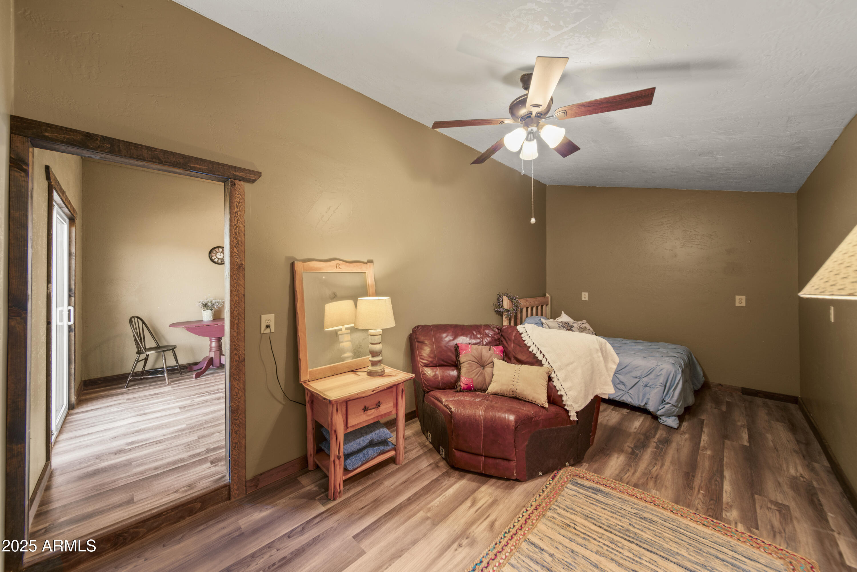 18330 Moonlight Mesa Road Wickenburg, AZ 85390 - Photo 18 of 31 a bedroom with bed and wooden floor