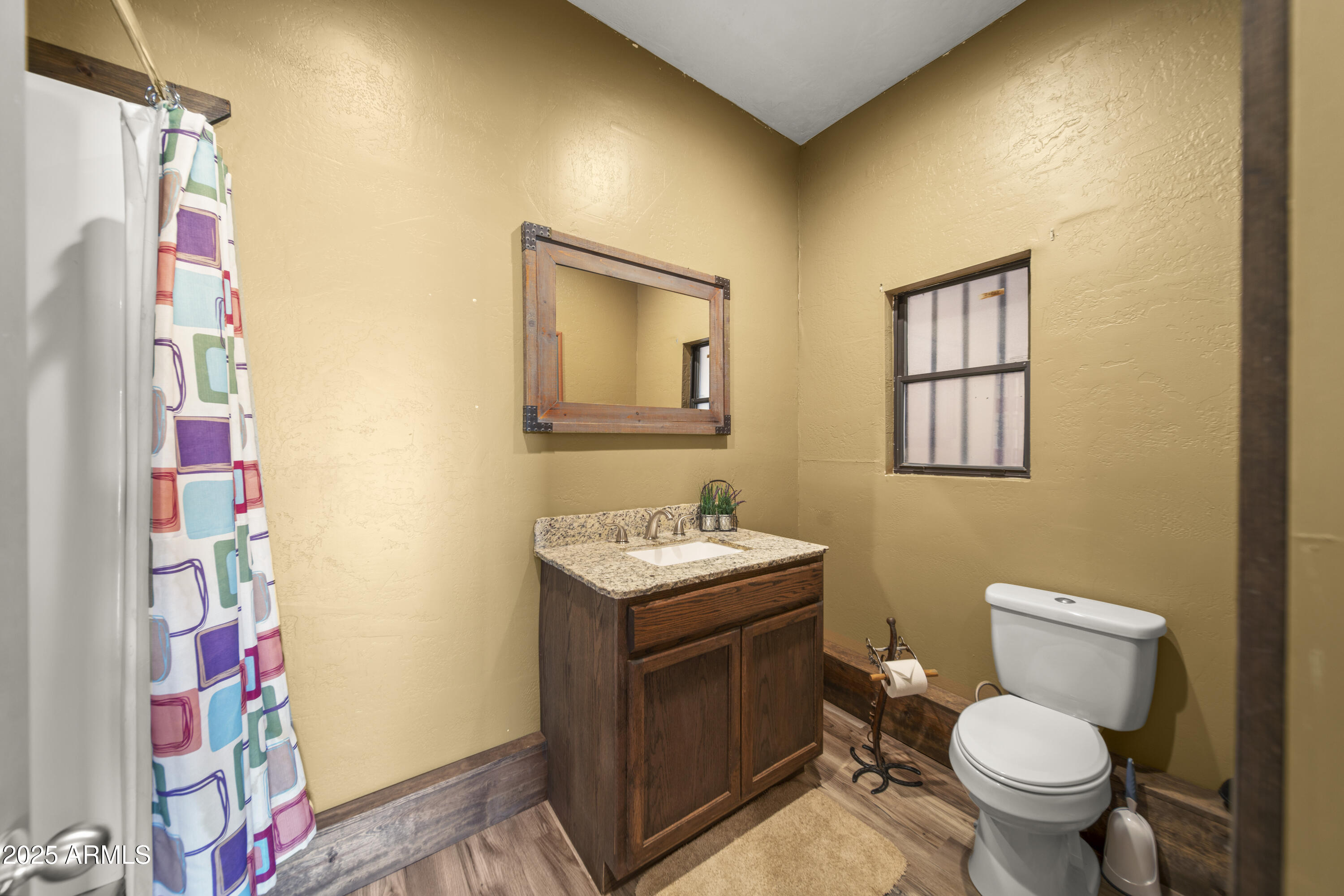 18330 Moonlight Mesa Road Wickenburg, AZ 85390 - Photo 19 of 31 a bathroom with a sink toilet vanity and wall