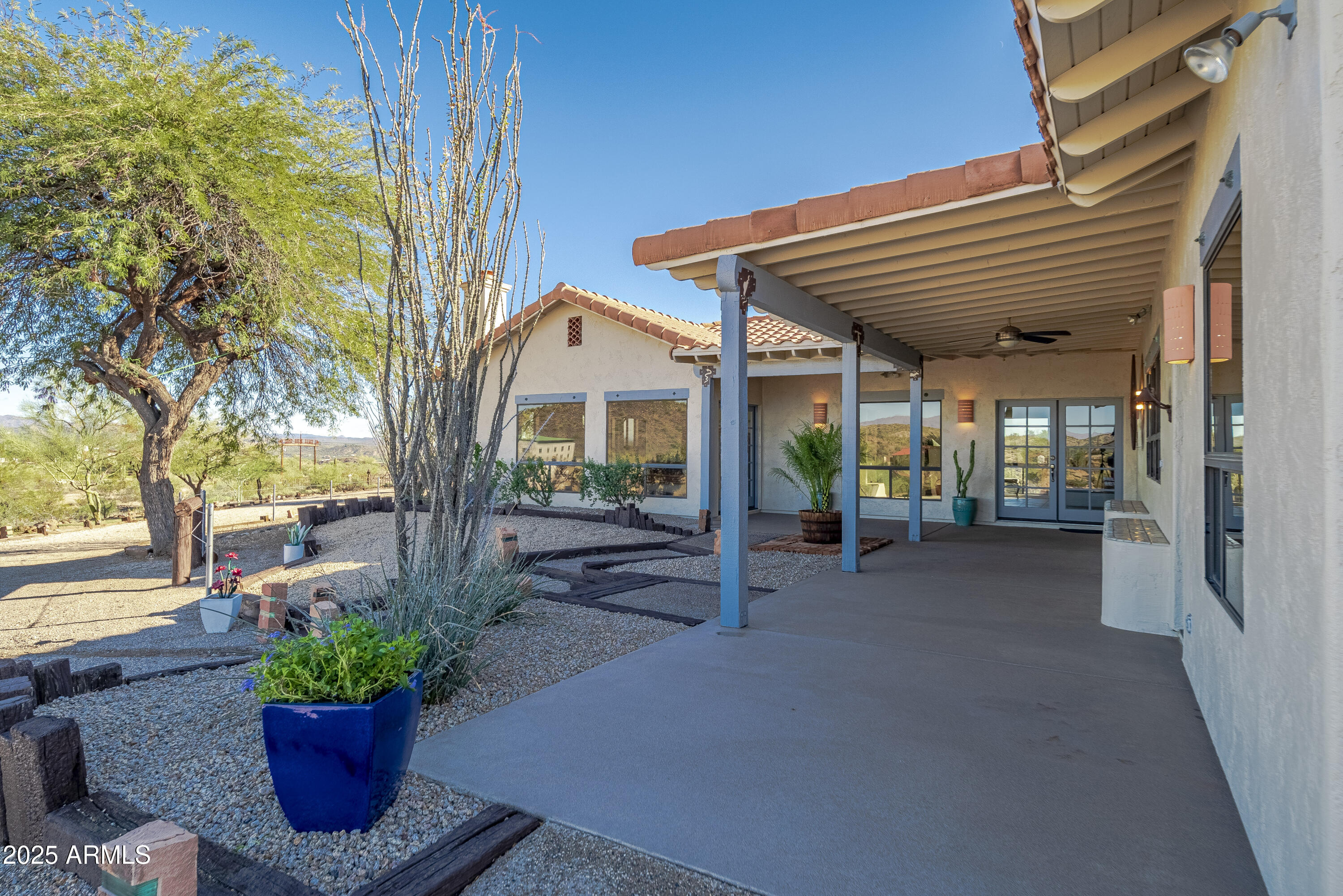 18330 Moonlight Mesa Road Wickenburg, AZ 85390 - Photo 2 of 31 a view of a house with a porch and garden