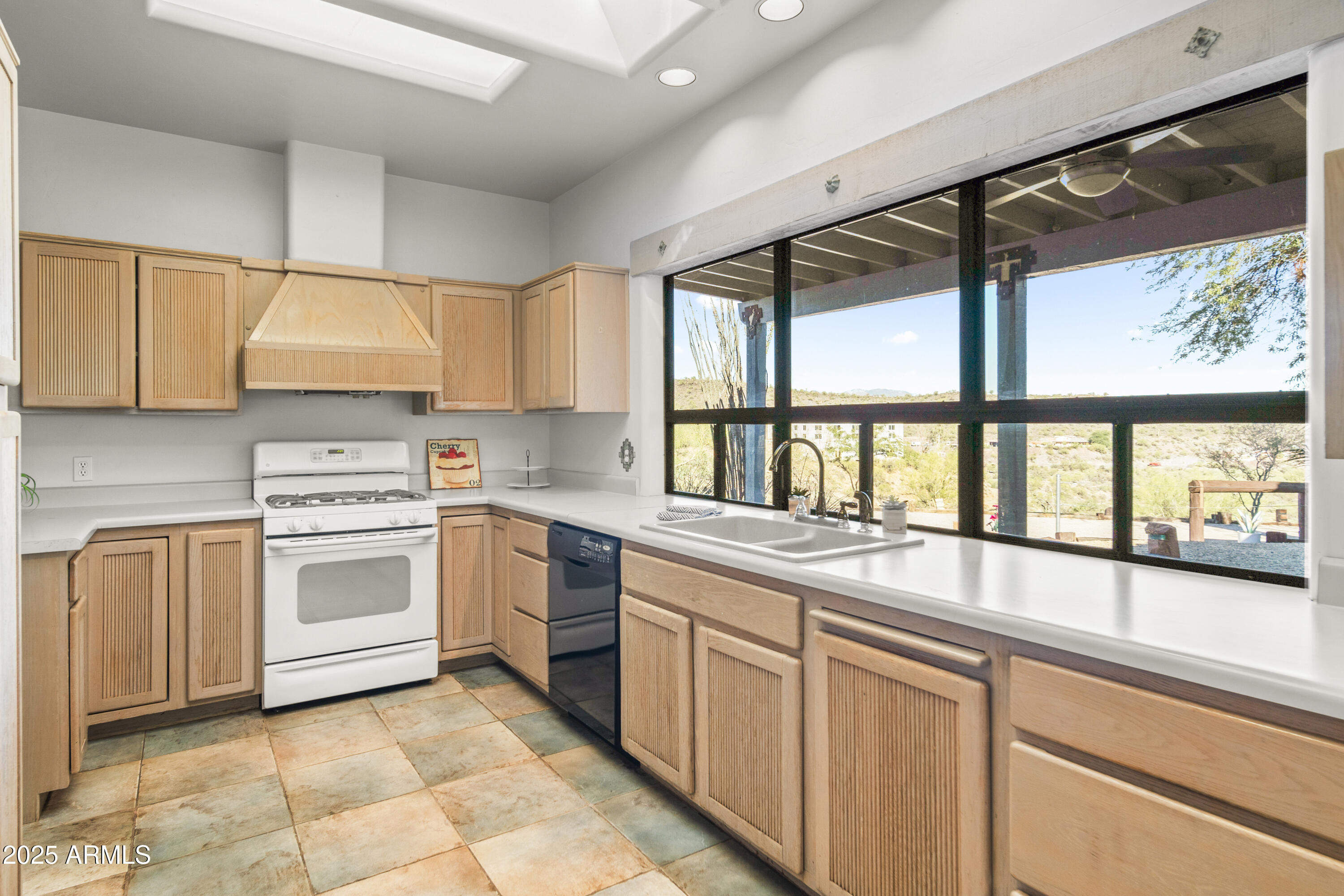 18330 Moonlight Mesa Road Wickenburg, AZ 85390 - Photo 23 of 31 a kitchen with a stove a sink and a microwave
