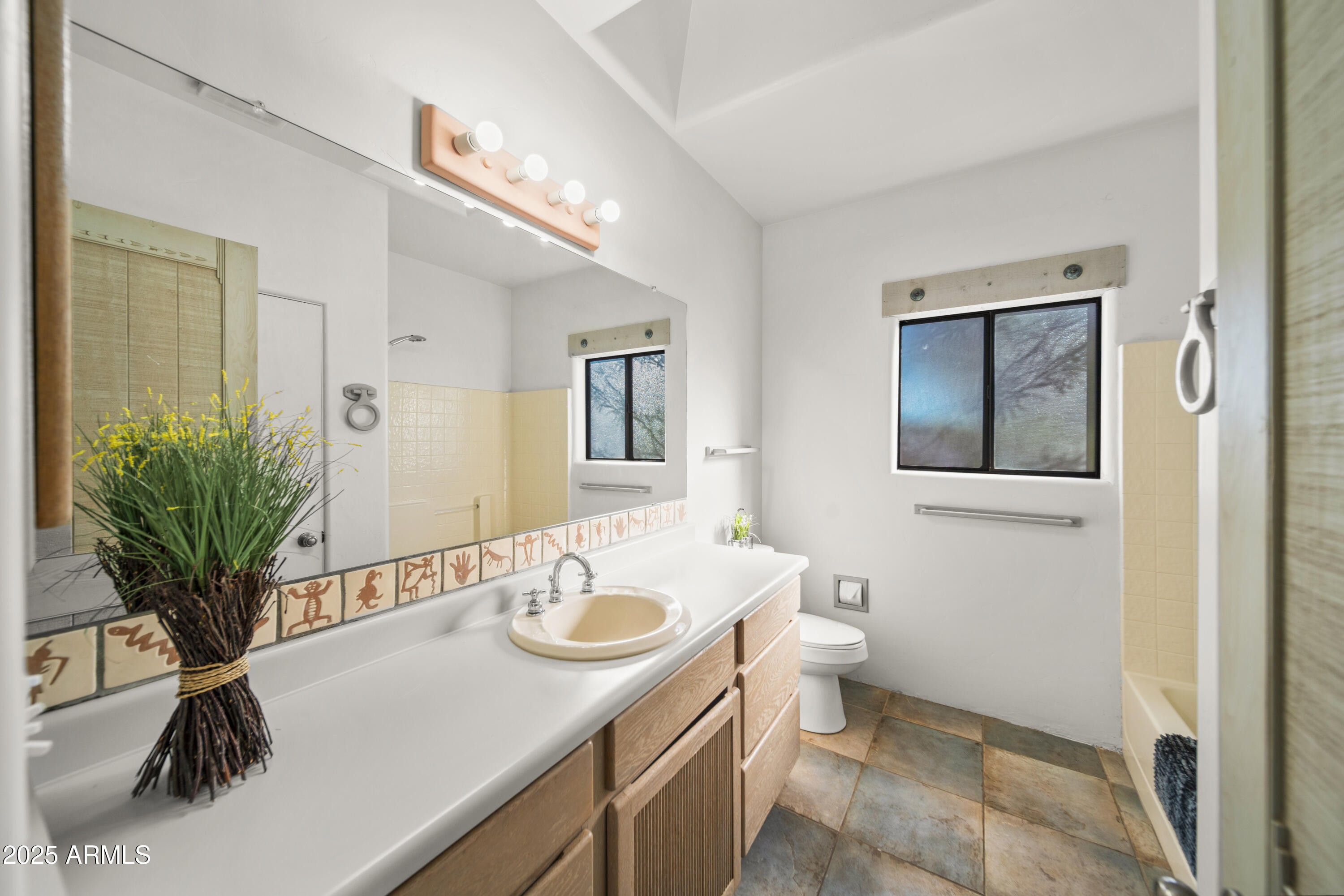 18330 Moonlight Mesa Road Wickenburg, AZ 85390 - Photo 26 of 31 a bathroom with a sink a toilet and a mirror