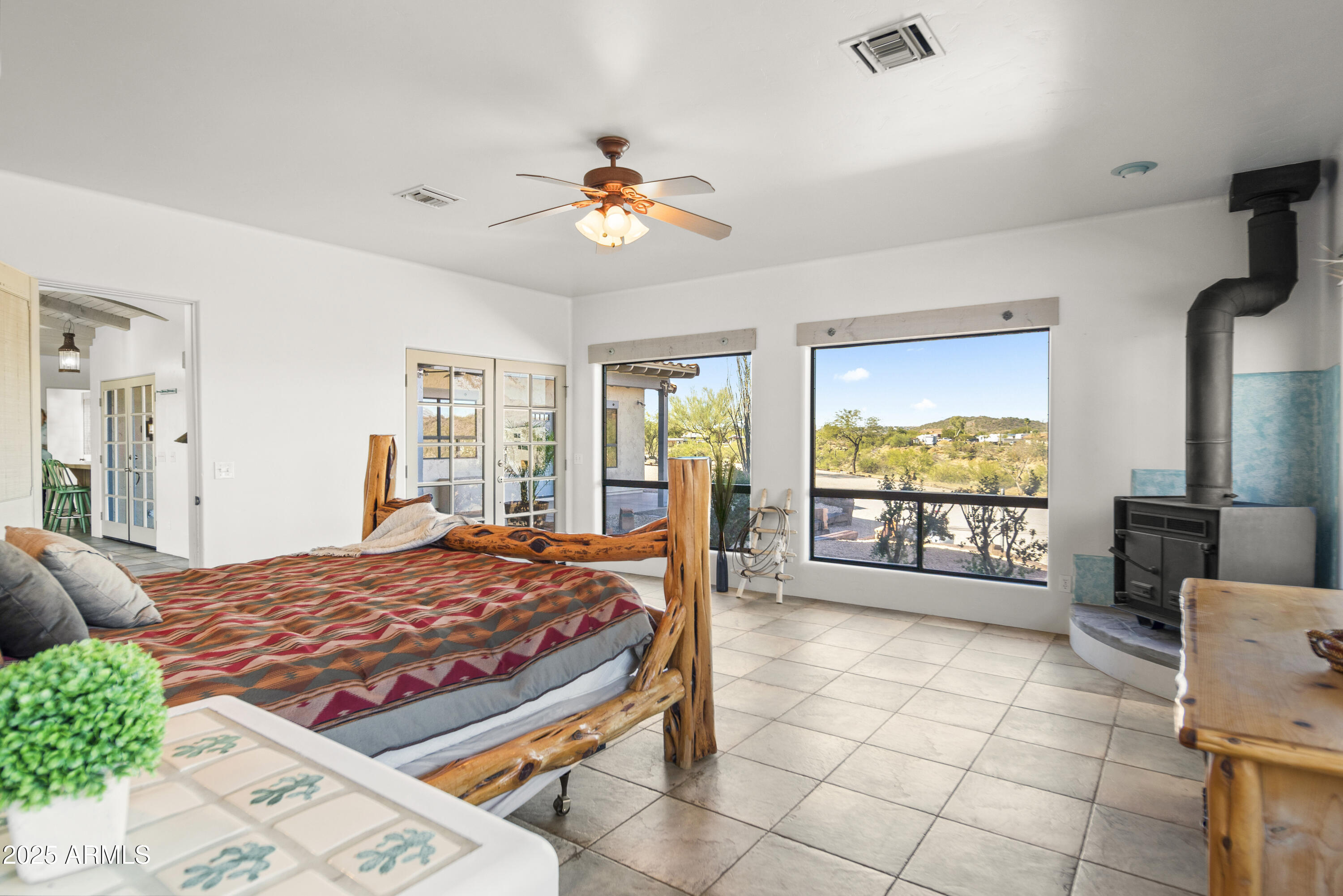 18330 Moonlight Mesa Road Wickenburg, AZ 85390 - Photo 4 of 31 a bedroom with a bed and large windows