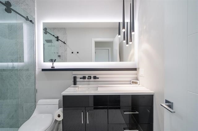 618 Madison Street, Unit 4 Hoboken, NJ 07030 - Photo 11 of 27 a bathroom with a sink a toilet and mirror