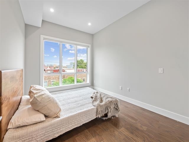 618 Madison Street, Unit 4 Hoboken, NJ 07030 - Photo 12 of 27 a bed sitting in a bedroom next to a window