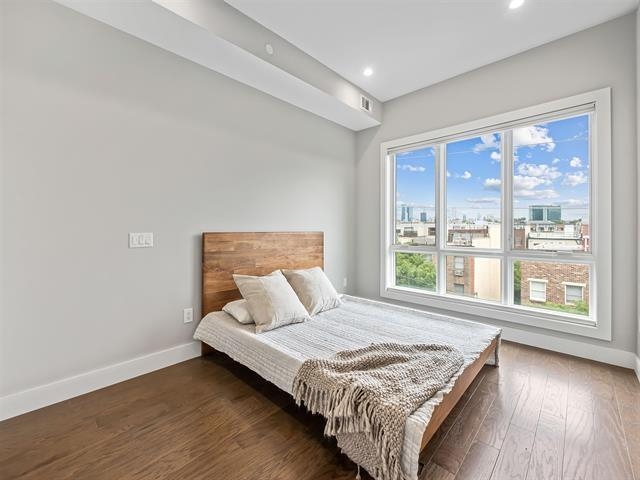 618 Madison Street, Unit 4 Hoboken, NJ 07030 - Photo 13 of 27 a bedroom with a bed and a large window