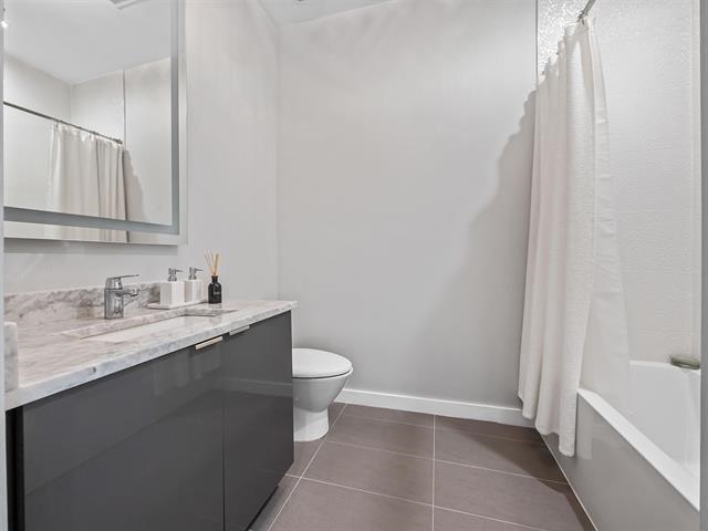 618 Madison Street, Unit 4 Hoboken, NJ 07030 - Photo 15 of 27 a bathroom with a granite countertop sink toilet and vanity