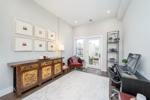 a bedroom with a bed a dresser and mirror