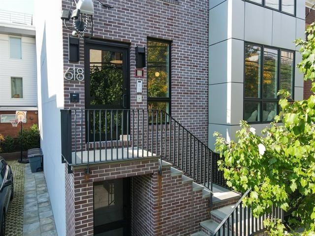 618 Madison Street, Unit 4 Hoboken, NJ 07030 - Photo 23 of 27 a view of a house with a small yard and plants