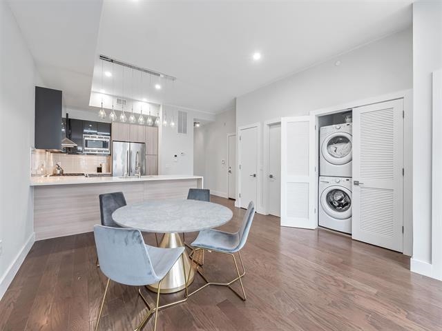 618 Madison Street, Unit 4 Hoboken, NJ 07030 - Photo 4 of 27 a living room with kitchen island a dining table chairs and wooden floor