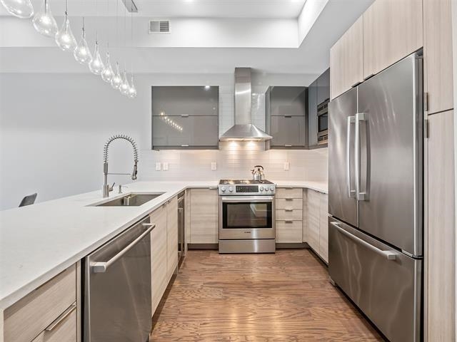 618 Madison Street, Unit 4 Hoboken, NJ 07030 - Photo 5 of 27 a kitchen with a sink stainless steel appliances and cabinets