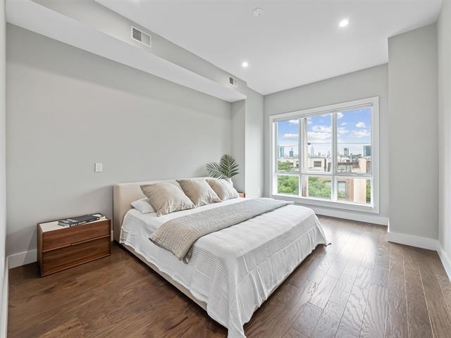 618 Madison Street, Unit 4 Hoboken, NJ 07030 - Photo 8 of 27 a large bed sitting in a bedroom next to a window