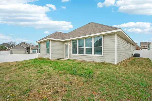a view of a house with a backyard