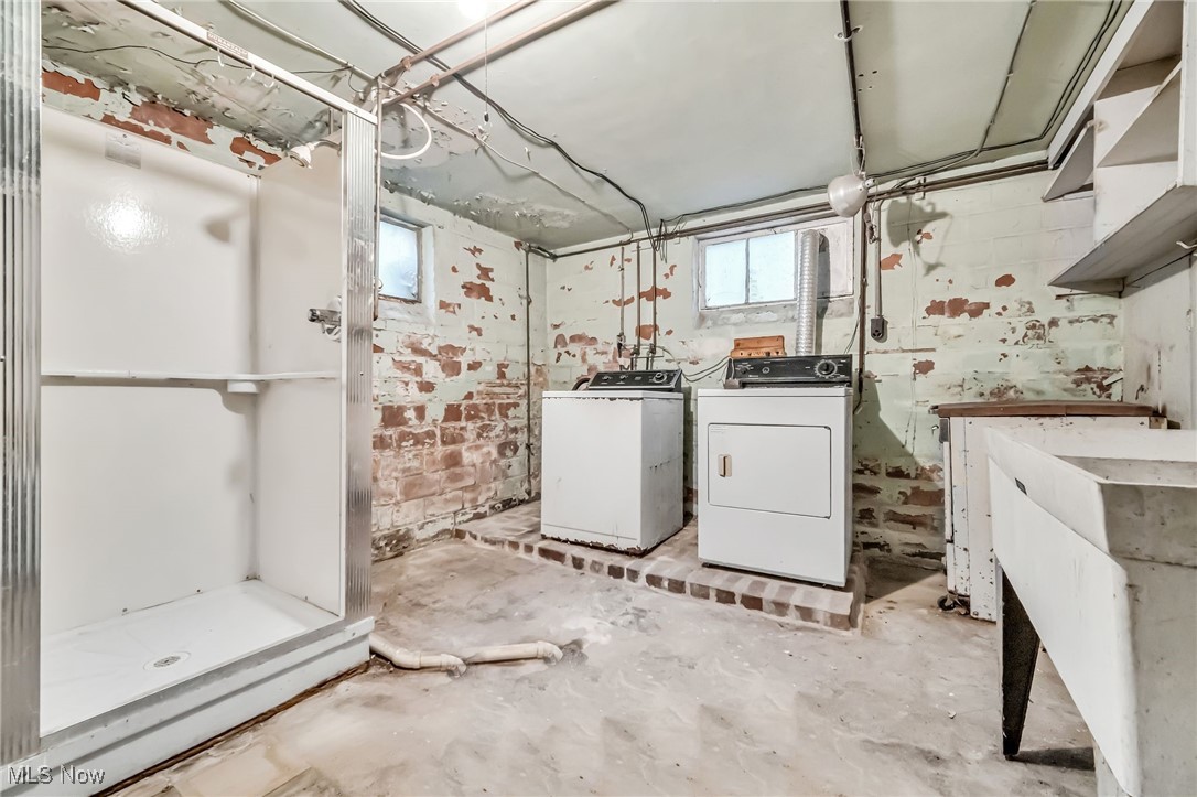 14608 Triskett Road Cleveland, OH 44111 - Photo 22 of 31 Laundry room with unfinished concrete flooring and independent washer and dryer