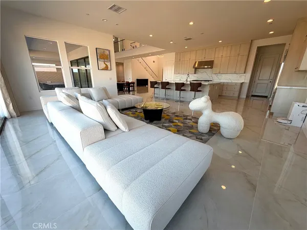 a living room with furniture and a large mirror