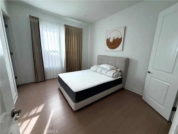 a bed sitting in a bedroom next to a window