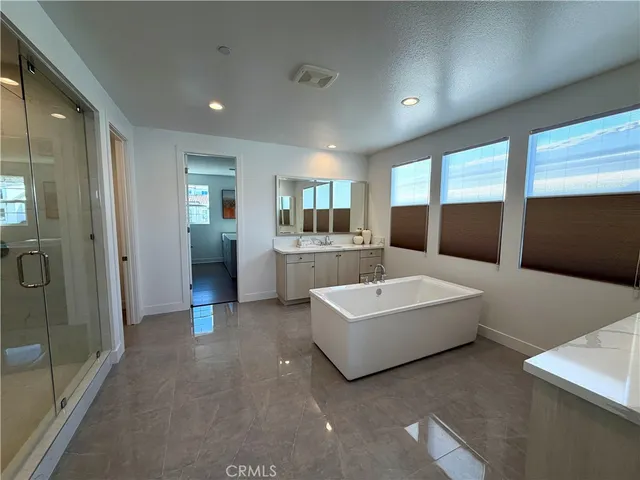 a large white room with a large window and furniture