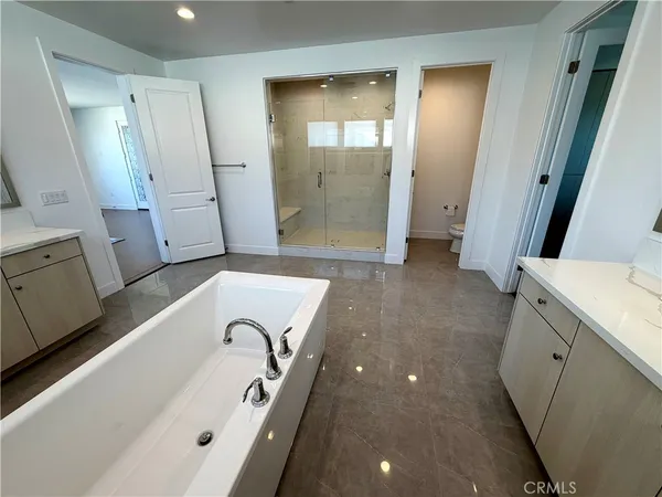 a bathroom with a tub sink and mirror