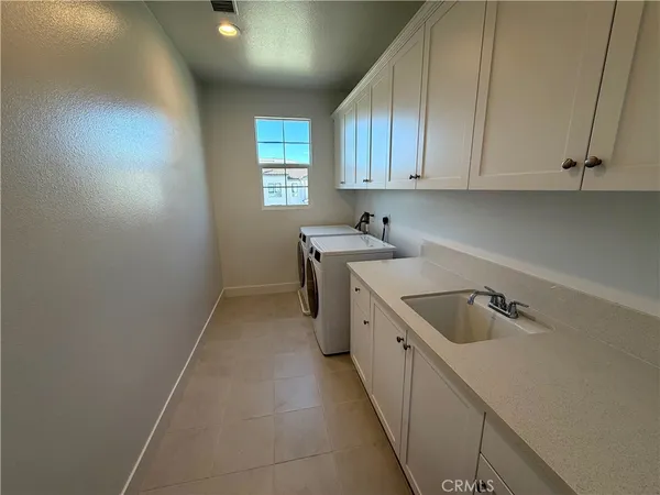 a kitchen that has a sink and cabinets
