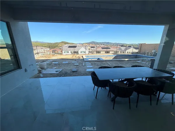 a view of a dining room with furniture and window