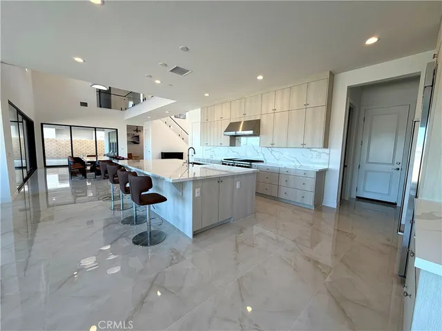 a large kitchen with stainless steel appliances lots of counter top space