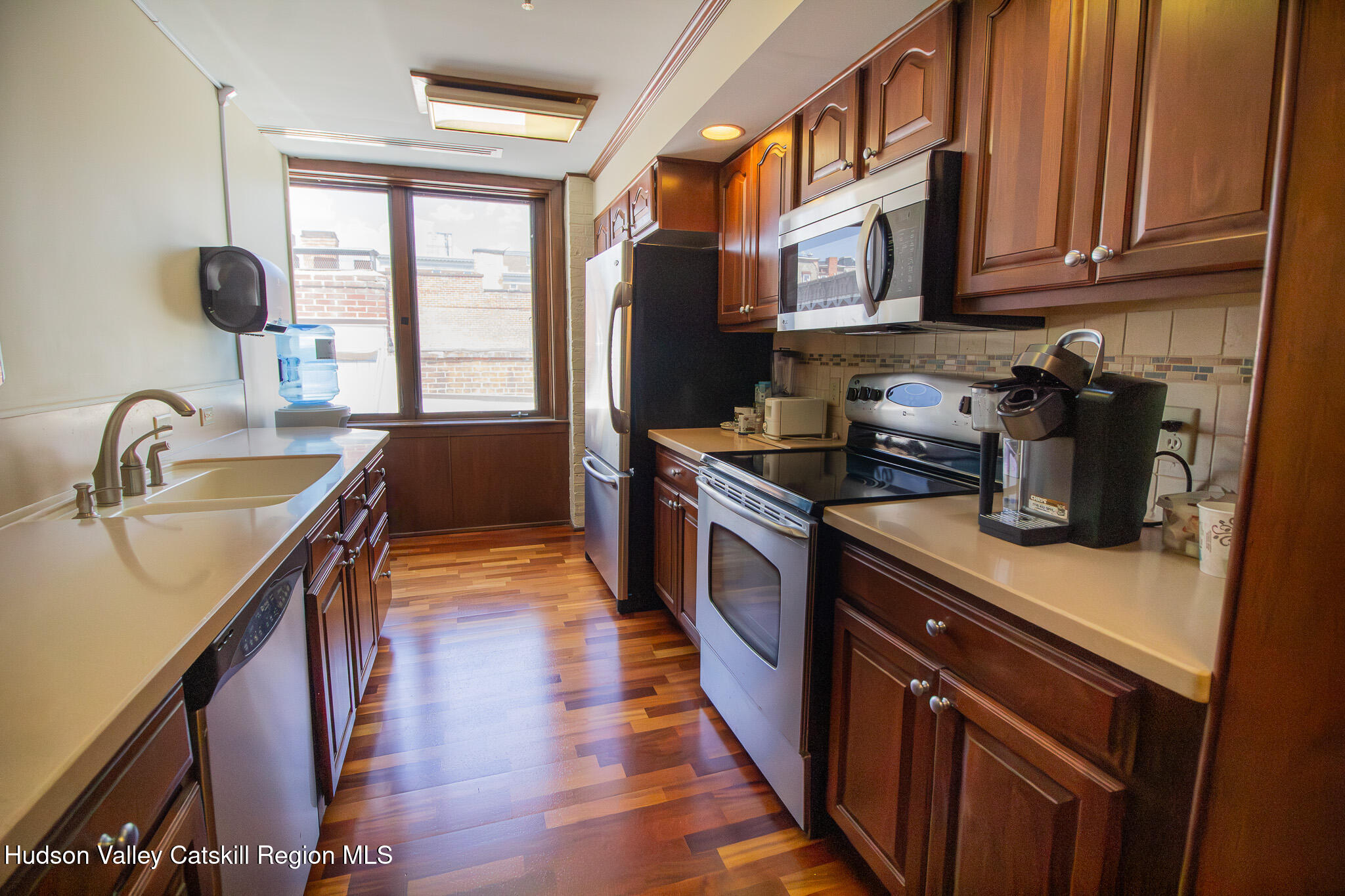 28 2nd Street Troy, NY 12180 - Photo 19 of 27 a kitchen with stainless steel appliances granite countertop a sink stove and refrigerator