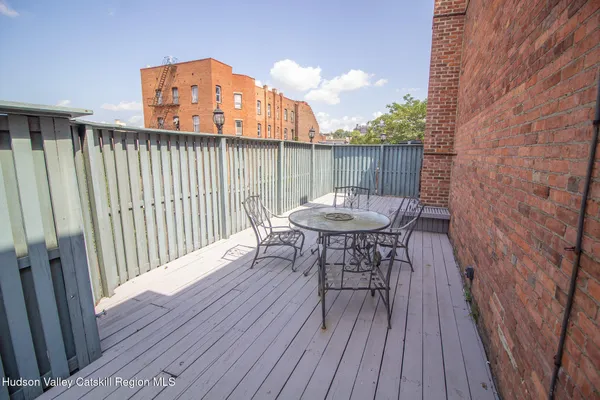 a view of a balcony with table and chairs