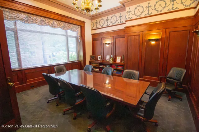 a dining room with furniture and window