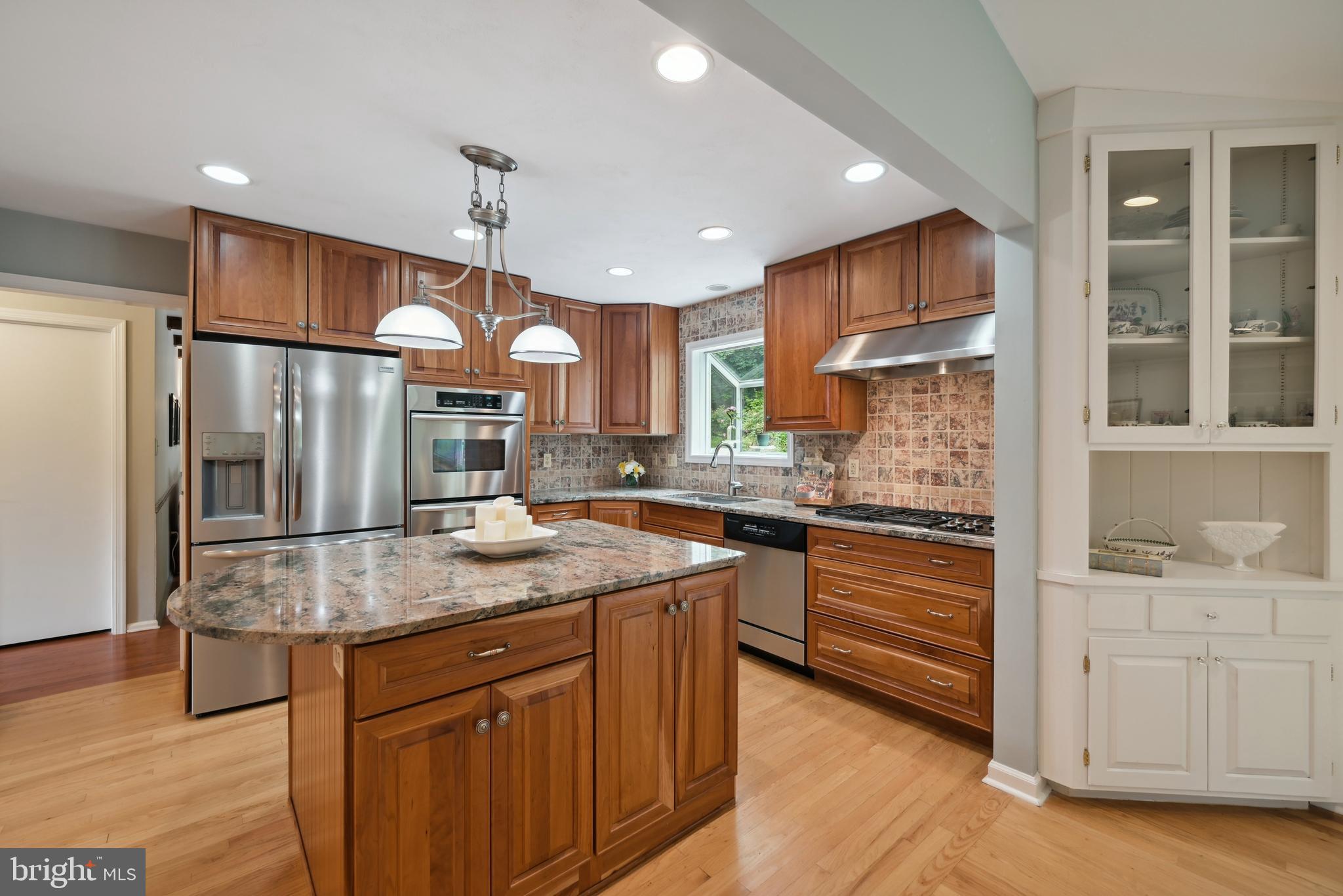 16 Fieldston Road West Windsor, NJ 08550 - Photo 12 of 34 a kitchen with stainless steel appliances granite countertop a sink a stove and a refrigerator