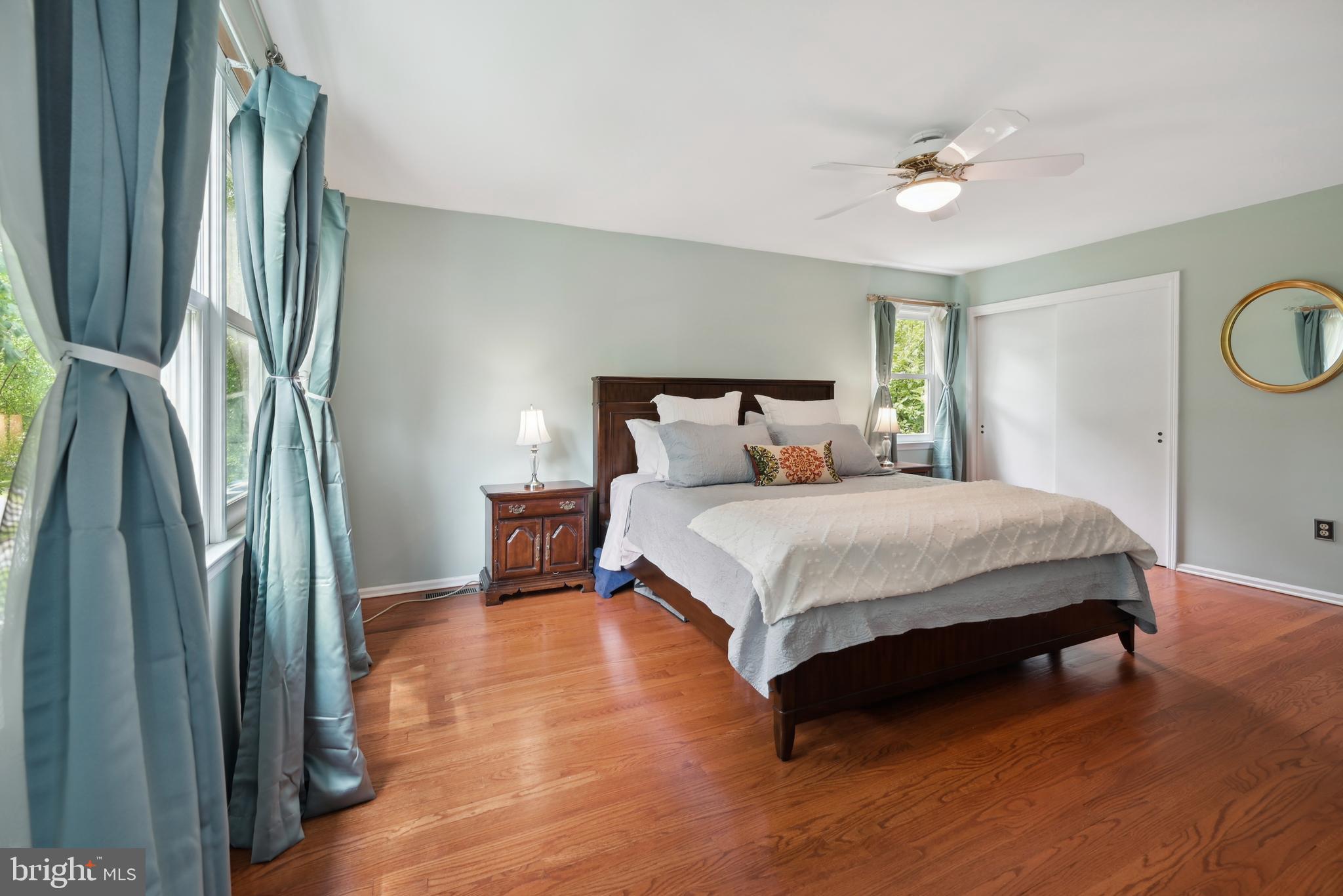 16 Fieldston Road West Windsor, NJ 08550 - Photo 21 of 34 a bedroom with a bed lamp and a large mirror