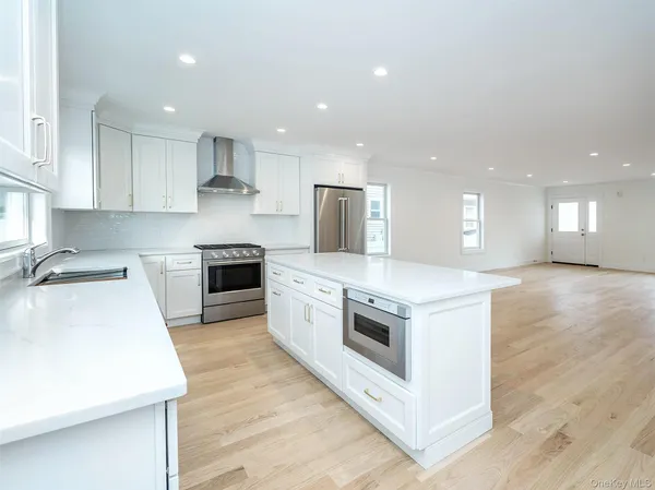a kitchen with a stove a sink and a refrigerator