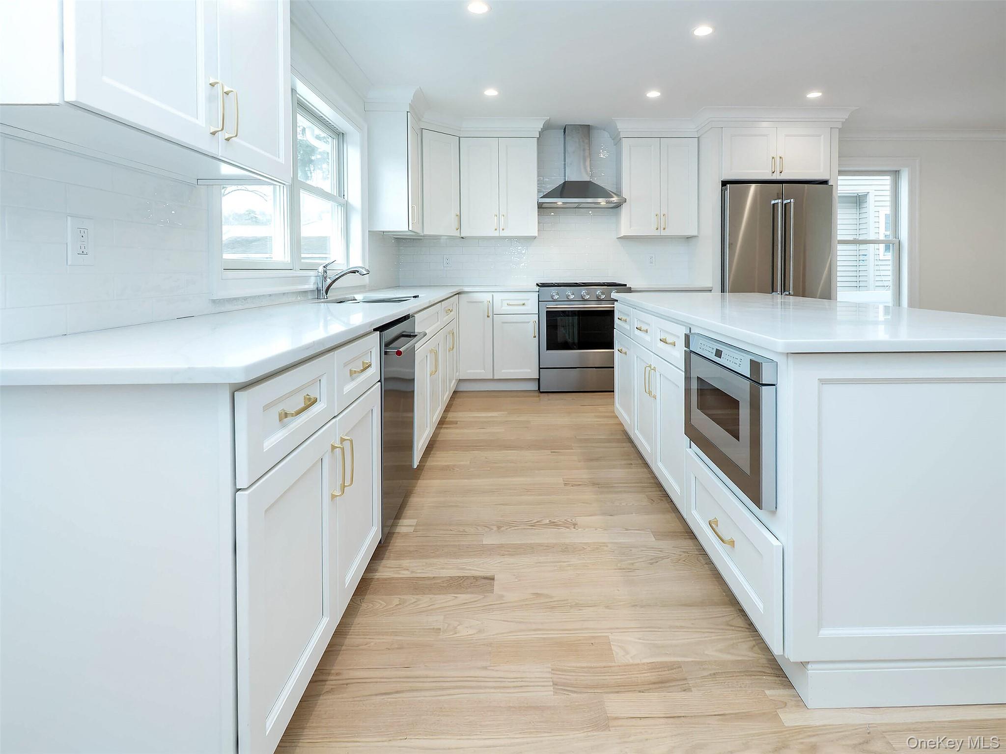 35 B Dunwood Road Port Washington, NY 11050 - Photo 11 of 35 a kitchen with stainless steel appliances granite countertop a stove top oven a sink and white cabinets