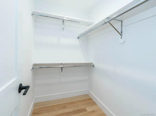 a bathroom with a granite countertop toilet a mirror and a shower