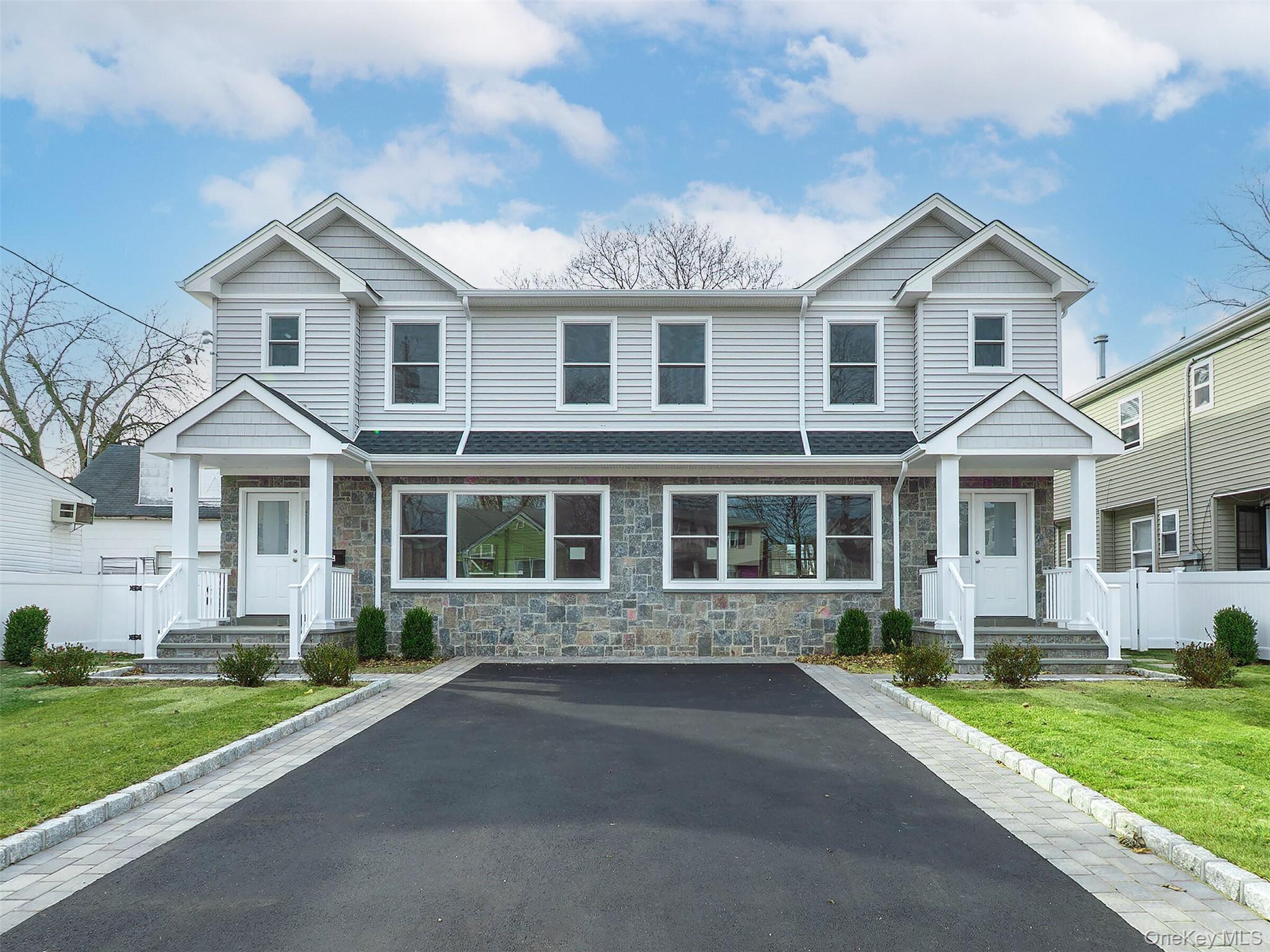 35 B Dunwood Road Port Washington, NY 11050 - Photo 2 of 35 a front view of a house with a yard and porch
